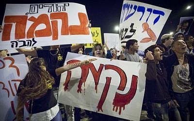 Right-wing activists carrying signs reading "Revenge" and "Death to Terrorists" protest at the site where a young Palestinian man rammed his car into pedestrians waiting for the light rail in Jerusalem, October 23, 2014 (Photo credit: Miriam Alster/Flash90) Right-wing activists carrying signs reading "Revenge" and "Death to Terrorists" protest at the site where a young Palestinian man rammed his car into pedestrians waiting for the light rail in Jerusalem, October 23, 2014 (Photo credit: Miriam Alster/Flash90)