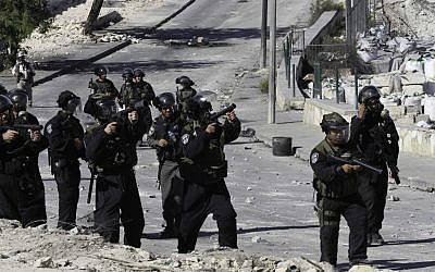 Israeli police shoot tear gas to disperse Palestinian youths throwing rocks in East Jerusalem, on October 24, 2014. (Photo credit: Sliman Khader/Flash90)