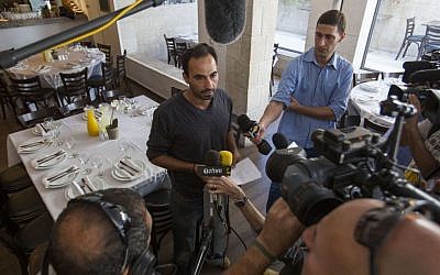 The owner of the Terasa restaurant, located at the Menachem Begin Center in Jerusalem, speaks to press on October 30, 2014, a day after the attempted assassination of Temple Mount Movement Leader, Yehudah Glick. (Photo  credit: Noam Revkin Fenton/Flash90)