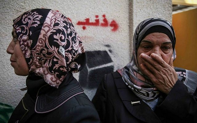 Family members seen taking shelter from tear gas while mourning at the home of the Palestinian man from the East Jerusalem neighborhood of Abu Tor suspected of the attempted murder of Yehudah Glick, October 30, 2014. (Hadas Parush/ Flash90) Family members seen taking shelter from tear gas while mourning at the home of the Palestinian man from the East Jerusalem neighborhood of Abu Tor suspected of the attempted murder of Yehudah Glick, October 30, 2014. (Hadas Parush/ Flash90)