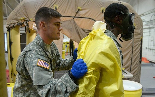 Members of the US Army's 101st Airborne Division conduct a training exercise at Ft. Campbell, Ky., Thursday, Oct. 9, 2014. Members will travel to Liberia to build treatment centers and conduct medical training as part of the fight against the Ebola epidemic. (photo credit: AP Photo/The Courier-Journal, Stephen Lance Dennee) Members of the US Army's 101st Airborne Division conduct a training exercise at Ft. Campbell, Ky., Thursday, Oct. 9, 2014. Members will travel to Liberia to build treatment centers and conduct medical training as part of the fight against the Ebola epidemic. (photo credit: AP Photo/The Courier-Journal, Stephen Lance Dennee)