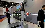 Visitors walk past a model of Rafael's C-Dome presented at the Euronaval show, in Le Bourget, north of Paris, Thursday, Oct. 30, 2014. (AP Photo/Christophe Ena)