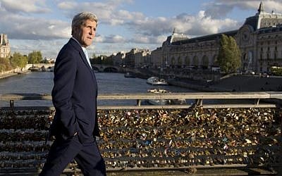 US Secretary of State John Kerry walks across the Seine on the Pont des Arts walking bridge on his way to meet with French Foreign Minister Laurent Fabius at the Quai d'Orsay, the Ministry of Foreign and European Affairs, in Paris, France, Monday Oct. 13, 2014. (photo credit: AP/Carolyn Kaster, Pool) 