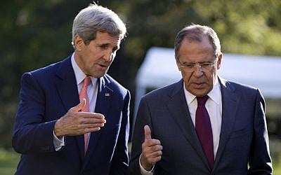 US Secretary of State John Kerry (left), and Russian Foreign Minister Sergey Lavrov talk as they walk together on the grounds of the Chief of Mission Residence in Paris, France, on October 14, 2014. (photo credit: AP/Carolyn Kaster, Pool) 