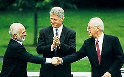 A handshake between Hussein I of Jordan and Yitzhak Rabin, accompanied by Bill Clinton, during the Israel-Jordan peace negotiations (Photo credit: White House, Public Domain)
