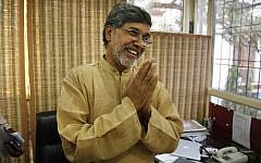 Indian children's rights activist Kailash Satyarthi gestures as he addresses the media at his office in New Delhi, India, Friday, Oct. 10, 2014. Malala Yousafzai of Pakistan and Satyarthi of India jointly won the Nobel Peace Prize on Friday, Oct. 10, 2014, for risking their lives to fight for children's rights. (photo credit: AP Photo/Manish Swarup)