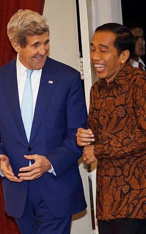 Indonesia's President Joko Widodo, right, meets U.S. Secretary of State John Kerry, left, at the presidential palace in Jakarta, Indonesia, Monday, Oct. 20, 2014. (photo credit: AP Photo/Tatan Syuflana)