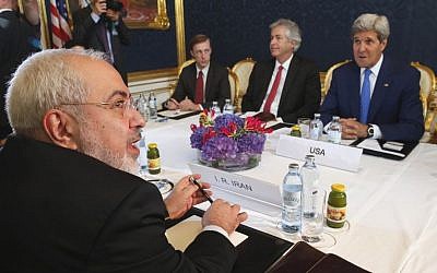 Iran's Foreign Minister Mohammad Javad Zarif, foreground left, holds a bilateral meeting with US Secretary of State John Kerry, background right, on the second day of talks, July 14, 2014, in Vienna, Austria. (photo credit: AP/Jim Bourg) 