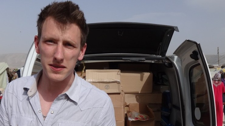 Peter Kassig standing in front of a truck filled with supplies for Syrian refugees. A video produced by militants in Syria released Friday, Oct. 3, 2014, shows Kassig, of Indianapolis, kneeling on the ground as a masked militant says he will be killed next. (photo credit: AP Photo/Courtesy Kassig Family) Peter Kassig standing in front of a truck filled with supplies for Syrian refugees. A video produced by militants in Syria released Friday, Oct. 3, 2014, shows Kassig, of Indianapolis, kneeling on the ground as a masked militant says he will be killed next. (photo credit: AP Photo/Courtesy Kassig Family)