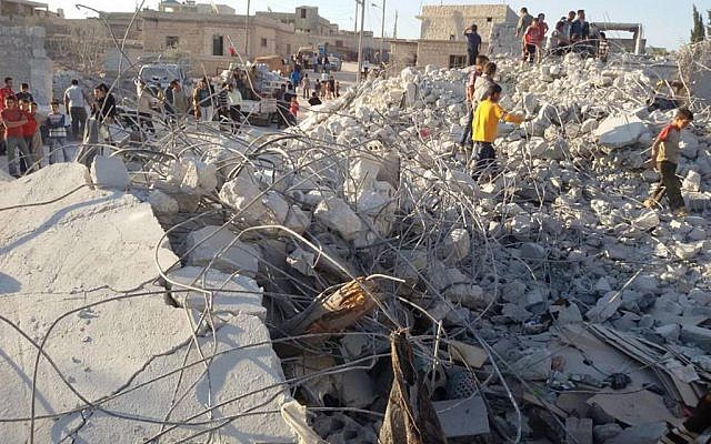 In this September 23, 2014 file photo, provided by an anti-Bashar Assad activist group Edlib News Network (ENN), which has been authenticated based on its contents and other AP reporting, shows Syrian citizens checking a damaged house that they say was targeted by the coalition airstrikes, in the village of Kfar Derian, a base for the al-Qaeda-linked Nusra Front, a rival of the Islamic State group, between the northern province of Aleppo and Idlib, Syria. (AP/Edlib News Network ENN, File) In this September 23, 2014 file photo, provided by an anti-Bashar Assad activist group Edlib News Network (ENN), which has been authenticated based on its contents and other AP reporting, shows Syrian citizens checking a damaged house that they say was targeted by the coalition airstrikes, in the village of Kfar Derian, a base for the al-Qaeda-linked Nusra Front, a rival of the Islamic State group, between the northern province of Aleppo and Idlib, Syria. (AP/Edlib News Network ENN, File)