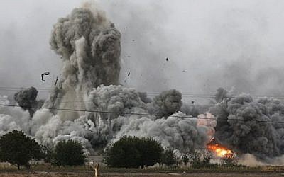Thick smoke, debris and fire rise following an airstrike by the US-led coalition in Kobani, Syria, as fighting intensified between Syrian Kurds and the militants of Islamic State group, as seen from Mursitpinar on the outskirts of Suruc, at the Turkey-Syria border, Sunday, Oct. 12, 2014. (photo credit: AP Photo/Lefteris Pitarakis)