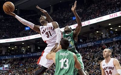 Toronto Raptors' Terrence Ross (31) drives against Maccabi Haifa's Jeff Allen (12) and Liraz Arieli (13) as Toronto's Greg Stiemsma, right, watches during the first half of an NBA exhibition basketball game Wednesday, Oct. 22, 2014, in Toronto. (AP Photo/The Canadian Press, Frank Gunn)