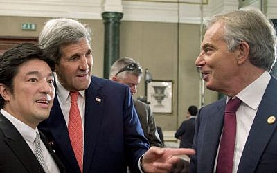 US Secretary of State John Kerry, center, speaks with Japanese Deputy Foreign Minister Yasuhide Nakayama, left, and Tony Blair, former British Prime Minister and Middle East Quartet envoy, in Cairo, Egypt, Sunday, Oct. 12, 2014, on the sidelines of a one-day conference to help Gaza rebuild after the war between Israel and Hamas. (Photo credit: AP/Carolyn Kaster, Pool)