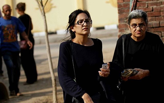 In this file photo taken Sunday, Oct. 26, 2014, Mona Seif, left, and her mother Laila Soueif, a university professor who is also an activist, stand outside a court that convicted 23 activists of staging an illegal demonstration and sentenced them each to three years in jail, in Cairo, Egypt. (AP Photo/Hussein Tallal, File)