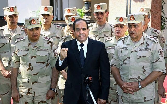 File: Egyptian President Abdel-Fattah el-Sissi, center, speaks in front of the state-run TV ahead of a military funeral for 30 troops killed in an assault in the Sinai Peninsula, as he stands with army commanders in Cairo, Egypt, October 25, 2014 (AP/MENA) File: Egyptian President Abdel-Fattah el-Sissi, center, speaks in front of the state-run TV ahead of a military funeral for 30 troops killed in an assault in the Sinai Peninsula, as he stands with army commanders in Cairo, Egypt, October 25, 2014 (AP/MENA)