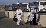 Palestinian pilgrims cross the Beit Hanoun checkpoint on their way to the Erez border crossing between Israel and Gaza and then to Jerusalem, during the three-day Muslim holiday of Eid al-Adha, in the northern Gaza Strip, Sunday, Oct. 5, 2014. (photo credit: AP/Adel Hana)