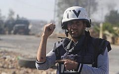 In this Sunday Oct. 26, 2014 photo, Associated Press photographer Majdi Mohammed shows his bruised arm after he was shot with a rubber bullet by Israeli border policeman in the village of Silwad, West Bank. (photo credit: AP/Issam Rimawi)