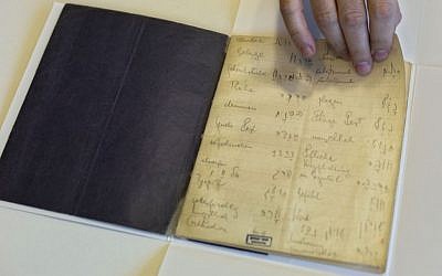 A library official shows celebrated author Franz Kafka’s Hebrew vocabulary notebook at Israel’s National Library in Jerusalem, October 2014. (AP Photo/Sebastian Scheiner)