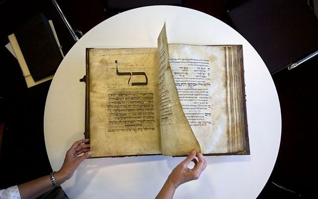 A library official shows a 13th-century German prayer book containing the earliest evidence of the Yiddish language, at Israel’s National Library in Jerusalem, October 5, 2014. (AP/Sebastian Scheiner) A library official shows a 13th-century German prayer book containing the earliest evidence of the Yiddish language, at Israel’s National Library in Jerusalem, October 5, 2014. (AP/Sebastian Scheiner)