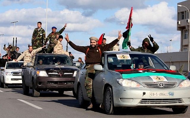In this Tuesday, Feb. 14, 2012 file photo, Libyan militias from towns throughout the country's west parade through Tripoli, Libya. (Photo credit: AP/Abdel Magid Al Fergany, File)