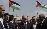 Palestinian Authority Prime Minister Rami Hamdallah (center), arrives at the Palestinian side of the Beit Hanoun border crossing in the northern Gaza Strip, Thursday, October 9, 2014. (photo credit: AP/Adel Hana)