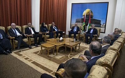 Palestinian Authority Prime Minister Rami Hamdallah and the ministers of Palestinian unity government meet with top Hamas leader in Gaza, Ismail Haniyeh, in Gaza City, Thursday, Oct. 9, 2014 (photo credit: AP Photo/Khalil Hamra)