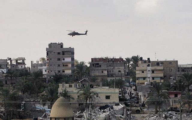 Illustrative: An Egyptian helicopter hovers over houses destroyed by the Egyptian army on the Egyptian side on the border town of Rafah, Wednesday, Oct. 29, 2014. (AP/Eyad Baba) Illustrative: An Egyptian helicopter hovers over houses destroyed by the Egyptian army on the Egyptian side on the border town of Rafah, Wednesday, Oct. 29, 2014. (AP/Eyad Baba)