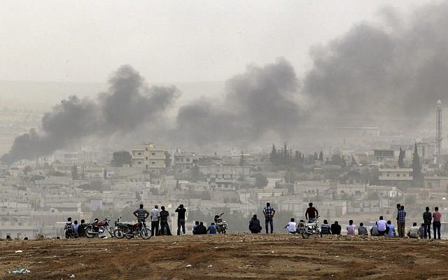 People on a hilltop watch smoke rising from a fire caused by a strike in Kobani, Syria, during fighting between Syrian Kurds and the militants of Islamic State group, on the outskirts of Suruc, at the Turkey-Syria border, on October 11, 2014. (AP Photo/Lefteris Pitarakis, File) People on a hilltop watch smoke rising from a fire caused by a strike in Kobani, Syria, during fighting between Syrian Kurds and the militants of Islamic State group, on the outskirts of Suruc, at the Turkey-Syria border, on October 11, 2014. (AP Photo/Lefteris Pitarakis, File)