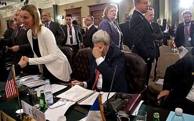 U.S Secretary of State John Kerry pauses to rub his face, in Cairo, Egypt, Sunday, Oct. 12, 2014, during the Gaza Donor Conference. (photo credit: AP Photo/Carolyn Aster, Pool)