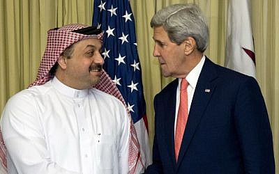 US Secretary of State John Kerry shakes hands with Qatari Foreign Minister Khalid bin Mohammad al-Attiyah in Cairo, Egypt, on Sunday, October 12, 2014, during the Gaza donor conference. (photo credit: AP/Carolyn Kaster, Pool)
