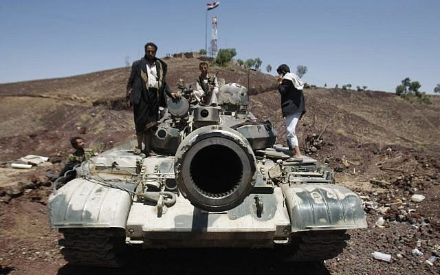 Hawthi Shiite rebels stand on a tank at the compound of the army's First Armored Division, after they had taken it over, in Sanaa, Yemen, Sept. 22, 2014. (photo credit: AP Photo/Hani Mohammed) Hawthi Shiite rebels stand on a tank at the compound of the army's First Armored Division, after they had taken it over, in Sanaa, Yemen, Sept. 22, 2014. (photo credit: AP Photo/Hani Mohammed)