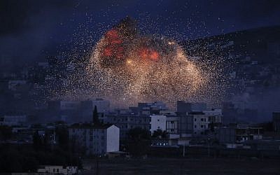 Thick smoke and flames from an airstrike by the US-led coalition rise in Kobani, Syria, Monday, Oct. 20, 2014. (photo credit: AP/Lefteris Pitarakis, File)