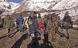 Nepalese Army soldiers carry an avalanche victim before he is airlifted in Thorong La pass area, Nepal, Wednesday, October 15, 2014. (photo credit: AP/Nepalese Army)