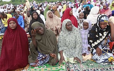 Nigeria Muslims offer Eid al-Adha prayers in Lagos, Nigeria, Saturday, Oct. 4, 2014. Muslims around the world will celebrate Eid al-Adha, the Festival of Sacrifice, to mark the end of the hajj pilgrimage by slaughtering sheep, goats, cows and camels to commemorate Prophet Abraham's readiness to sacrifice his son Ismail on God's command. (photo credit: AP Photo/Sunday Alamba)