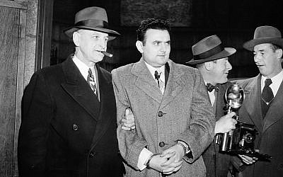 In this April 5, 1951, file photo, David Greenglass, second from left, is led into Federal Courthouse in New York by U.S. Deputy Marshall Eugene Fitzgerald, left, for sentencing as an atom spy. Greenglass, whose testimony led to the conviction and execution of his sister, Ethel Rosenberg and brother-in-law, Julius Rosenberg, has died at 92. (photo credit: AP Photo/File)