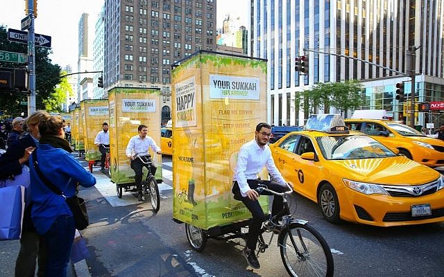 A fleet of pedi-sukkahs cruise through New York City. (Photo credit: Chabad.org / JTA)