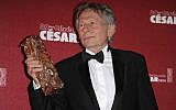 Polish-French film director Roman Polanski holds his best director award during the 39th French Cesar Awards Ceremony in Paris, Friday Feb. 28, 2014. (photo credit: AP/Lionel Cironneau, File)