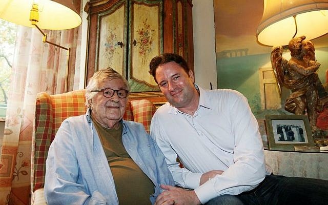 In this photo taken on Tuesday, Oct. 14, 2014, Gene Gutowski, left, who produced four of Roman Polanski’s films, poses with his son Adam Bardach at his home in Warsaw, Poland. (AP Photo/Czarek Sokolowski)