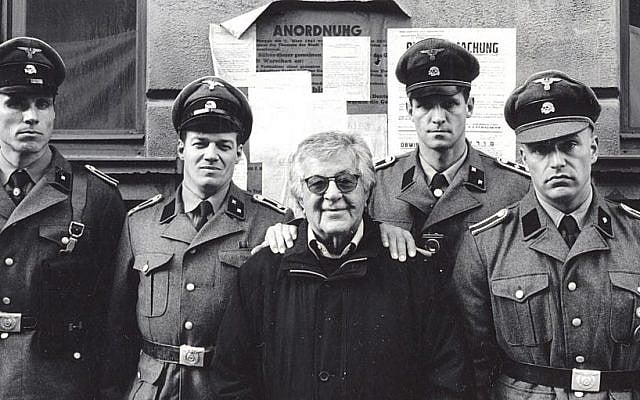 In this photo from 2001, provided by the Gutowski family, film producer Gene Gutowski, center, stands with actors playing Nazis on the set of “The Pianist.” (AP Photo/Guy Ferrandis)