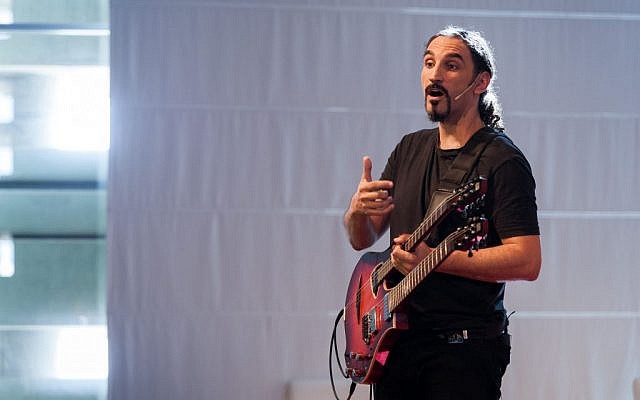 Yossi Sassi of the popular metal band Orphaned Land speakes about his bouzoukitara at TEDxJaffa2014 on October 23 (photo credit: Arthur Fuhrer/TEDxJaffa)