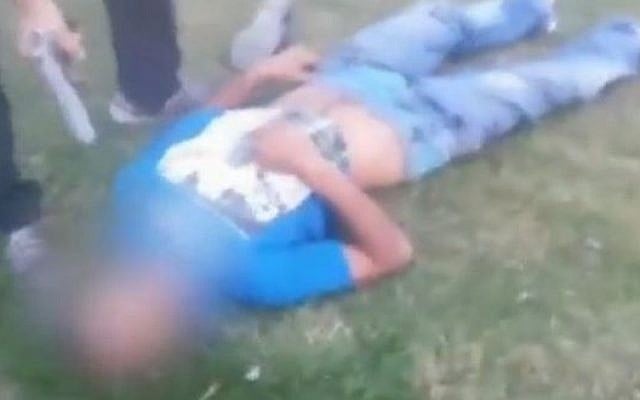 Screen capture from a video showing shot and injured Abdel Rahman Al-Shaludi lying on the ground after he drove a car into a crowd of pedestrians at a light rail stop in Jerusalem. Screen capture from a video showing shot and injured Abdel Rahman Al-Shaludi lying on the ground after he drove a car into a crowd of pedestrians at a light rail stop in Jerusalem.