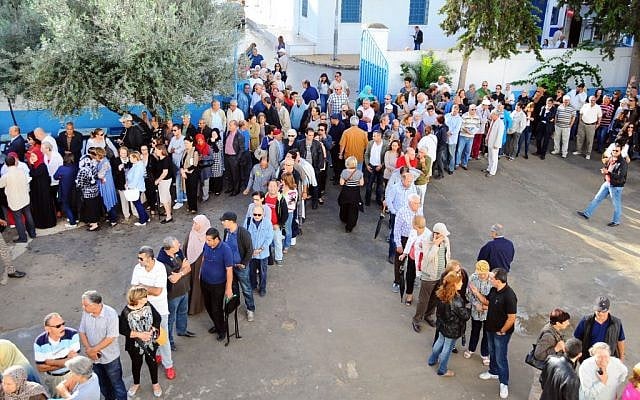 Tunisians queue outside a polling station in La Marsa, Tunisia, Sunday Oct. 26, 2014. (photo credit: AP/Hassene Dridi) Tunisians queue outside a polling station in La Marsa, Tunisia, Sunday Oct. 26, 2014. (photo credit: AP/Hassene Dridi)
