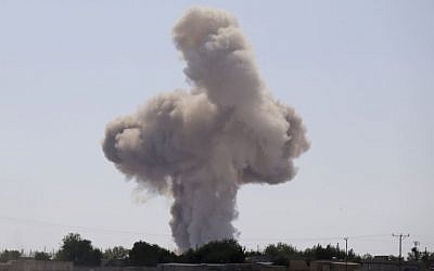A huge plume of smoke rises after an airstrike outside west Kobani, Syria as fighting intensified between Syrian Kurds and the militants of Islamic State group, as seen from Mursitpinar in the outskirts of Suruc, at the Turkey-Syria border, Wednesday, Oct. 8, 2014.  (Photo credit: AP/Lefteris Pitarakis)