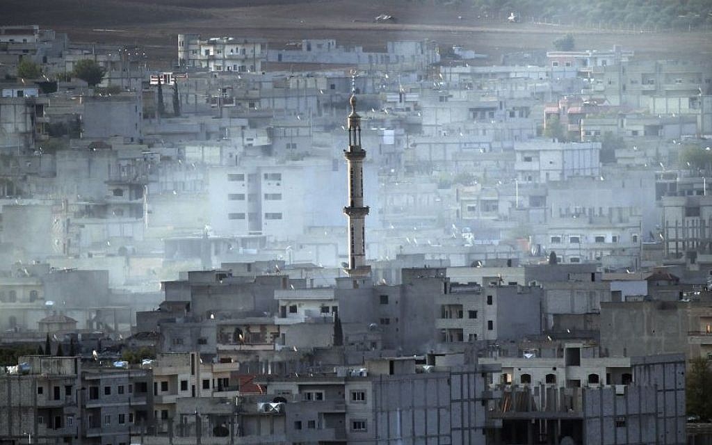 Smoke rises following a strike in Kobani, Syria while fighting continued between Syrian Kurds and the militants of Islamic State group, as seen from Mursitpinar on the outskirts of Suruc, at the Turkey-Syria border, Wednesday, Oct. 15, 2014. (Photo credit: AP/Lefteris Pitarakis)