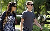 Facebook president and CEO Mark Zuckerberg with Priscilla Chan. (photo credit: AP Photo/Julie Jacobson, File)