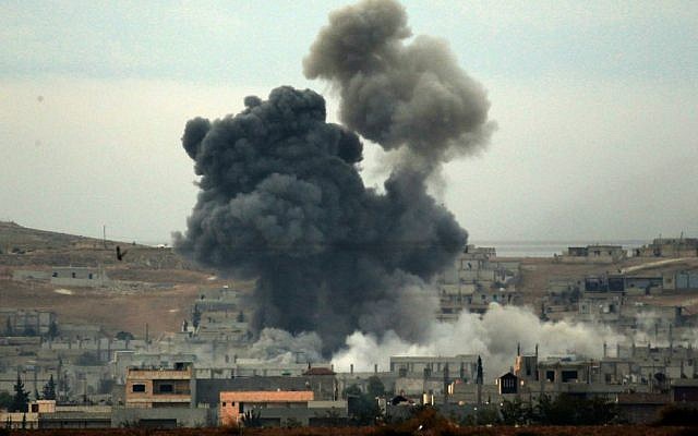 Thick smoke rises following an airstrike by the US-led coalition in Kobani, Syria while fighting continued between Syrian Kurds and the Islamic State group, as seen from Mursitpinar on the outskirts of Suruc, at the Turkey-Syria border, Oct. 14, 2014. (Photo credit: Lefteris Pitarakis/AP) Thick smoke rises following an airstrike by the US-led coalition in Kobani, Syria while fighting continued between Syrian Kurds and the Islamic State group, as seen from Mursitpinar on the outskirts of Suruc, at the Turkey-Syria border, Oct. 14, 2014. (Photo credit: Lefteris Pitarakis/AP)