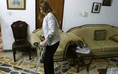 Iraqi MP Vian Dakhil walking with crutches in an interview on September 20, 2014 in Erbil, the capital of the Kurdish autonomous region in northern Iraq. (photo credit: Mohammed Sawaf/AFP)