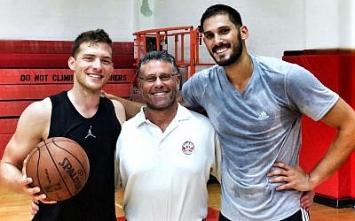 Trainer David Thorpe is flanked by two of his pupils -- Israelis Gal Mekel, left, and Omri Casspi, both playing in the NBA. (Courtesy David Thorpe/JTA)
