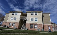 This Wednesday, Oct. 22, 2014, photo shows the apartment building in Aurora, Colo., which police say is the home of two of the three teenage girls who, according to U.S. authorities, were en route to join the Islamic State group in Syria when they were stopped at an airport in Germany. (photo credit: AP Photo/Brennan Linsley)