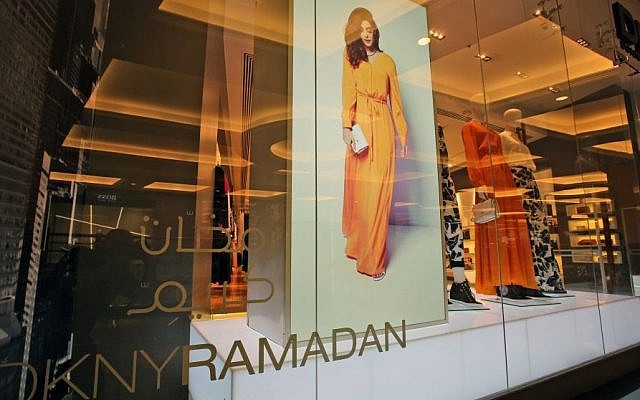 FILE- In this Tuesday, July 22, 2014 file photo, part of the DKNY Ramadan collection is seen on display at a shopping mall in Dubai, United Arab Emirates. Some mainstream fashion houses have started to cater to the growing demand for stylish modest wear. This summer, fashion house DKNY released a collection during the Islamic holy month of Ramadan that sold exclusively in the Arabian Gulf. (Photo credit: AP/Kamran Jebreili, File)